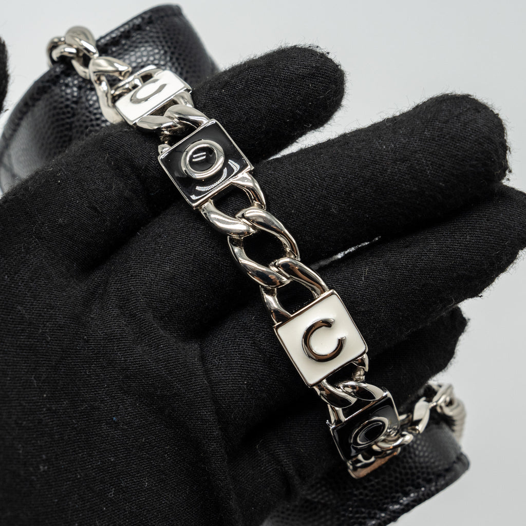 CHANEL 22S COCO LETTERING MINI FLAP BAG WITH ENAMEL TOP HANDLE CAVIAR BLACK SHW